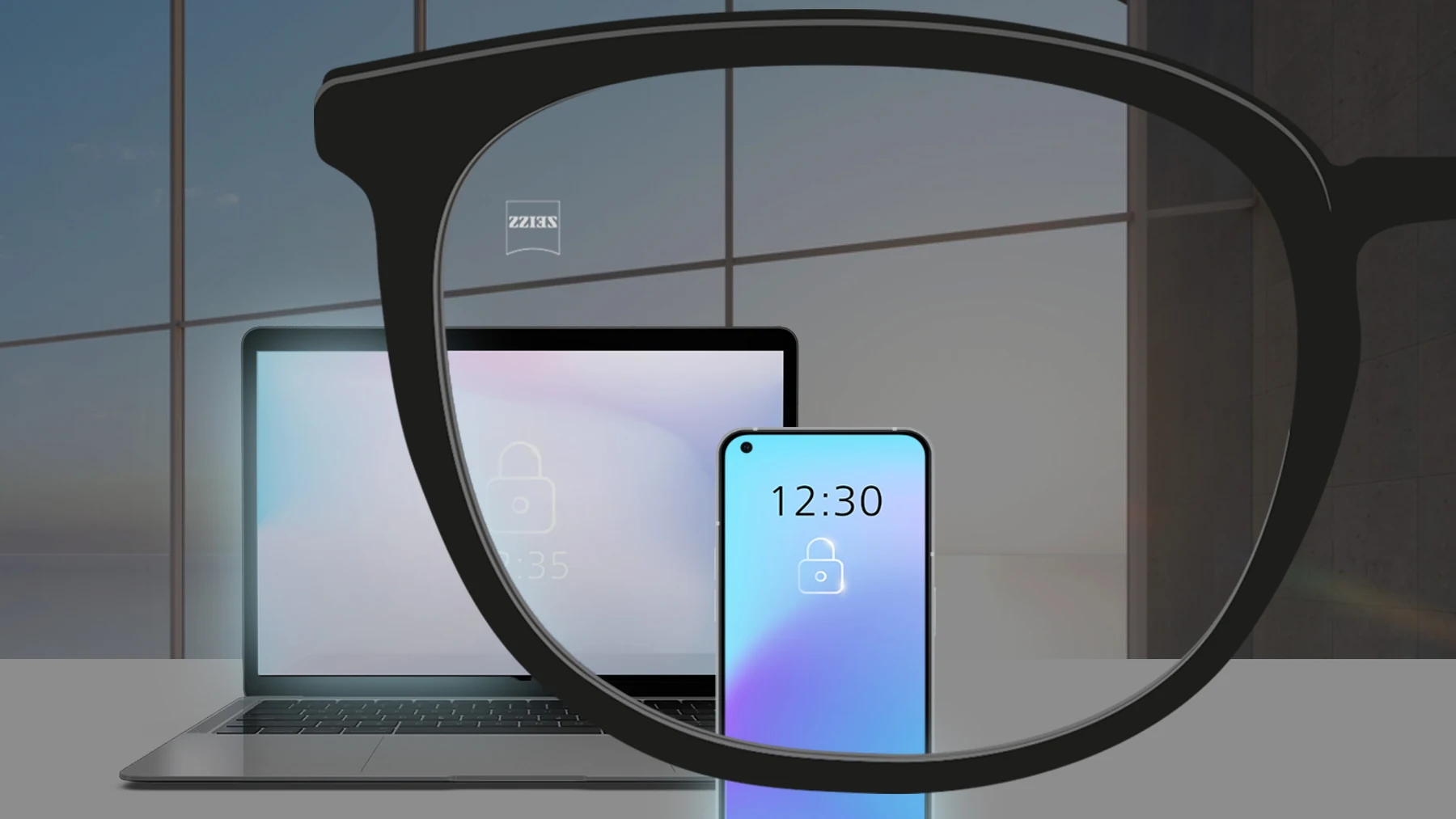 Lente ZEISS BlueGuard diante de um computador e de um celular